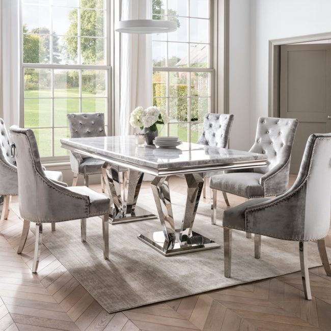 lavish_ Elegant dining room with an Arturo 180cm Marble Dining Table, tufted chairs, and a view of the garden through large windows, showcasing exquisite interior design.