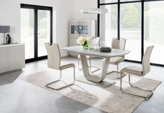 lavish_ Modern dining room with a Lazzaro Dining Table set for four, beige chairs, and large windows featuring Southport furniture.