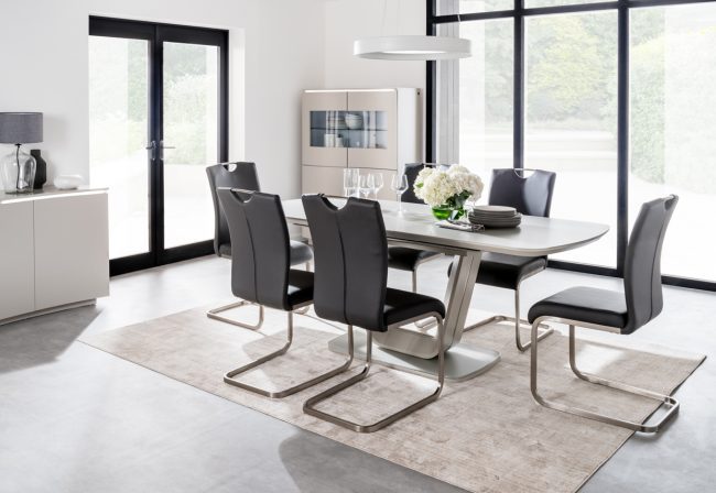 lavish_ Modern dining room with a Lazzaro Dining Table, six chairs, minimalist decor, and Southport-inspired furniture.
