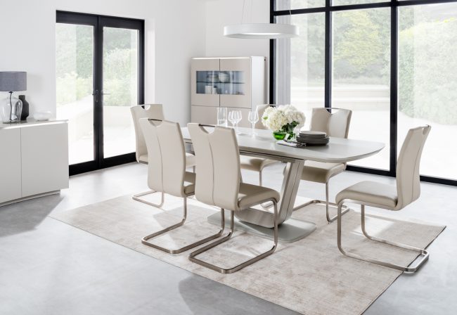 lavish_ Modern dining room with a Lazzaro Dining Table, six chairs, large windows, and stylish furniture.