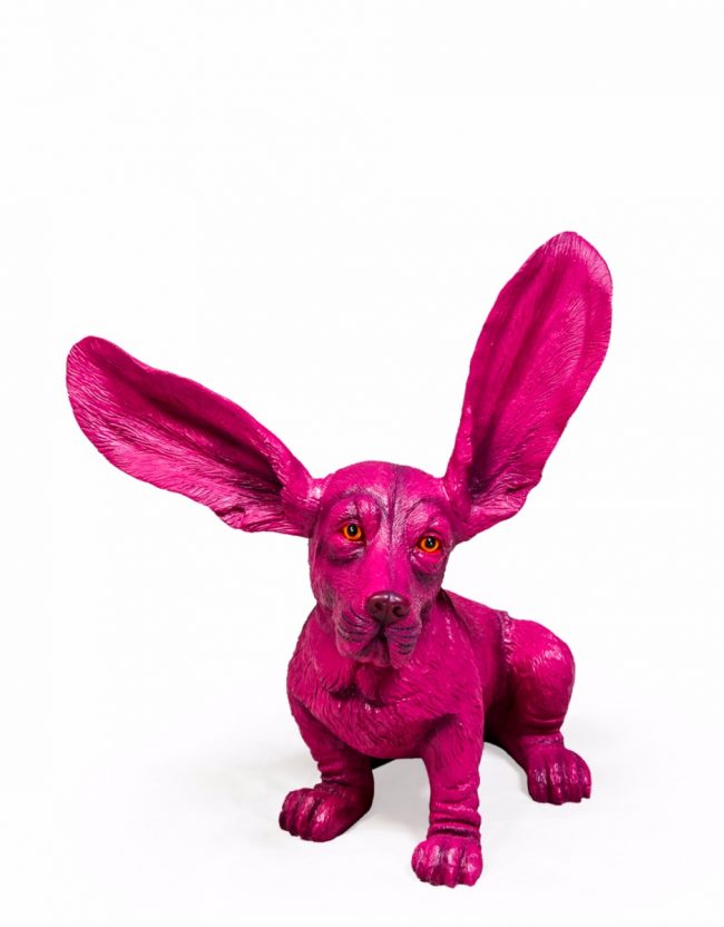 lavish_ A vibrant pink sculpture of a rabbit with exaggeratedly large ears, ideal for interior design, displayed against a white background.