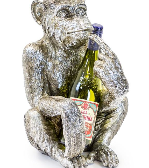 lavish_ A statue of a monkey sitting and holding a wine bottle, perfect as unique furniture for any Southport interior design.