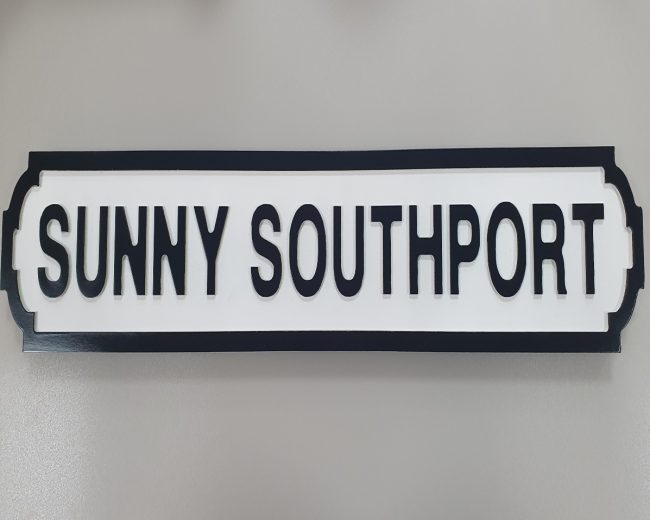 lavish_ A black and white Sunny Southport sign, perfect for interior design themes.