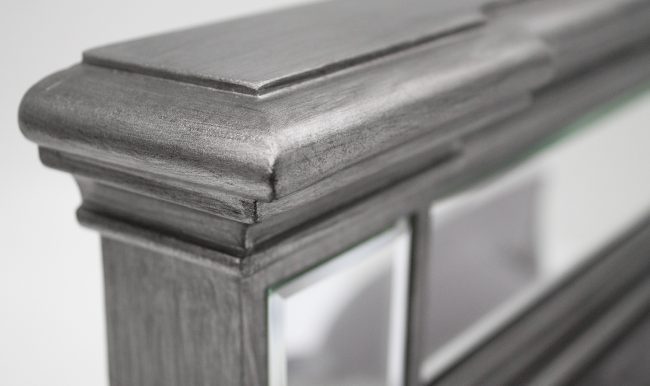 lavish_ Close-up of an Ophelia Bed - 5' Kingsize-inspired, gray-painted wooden picture frame corner with glass insert.