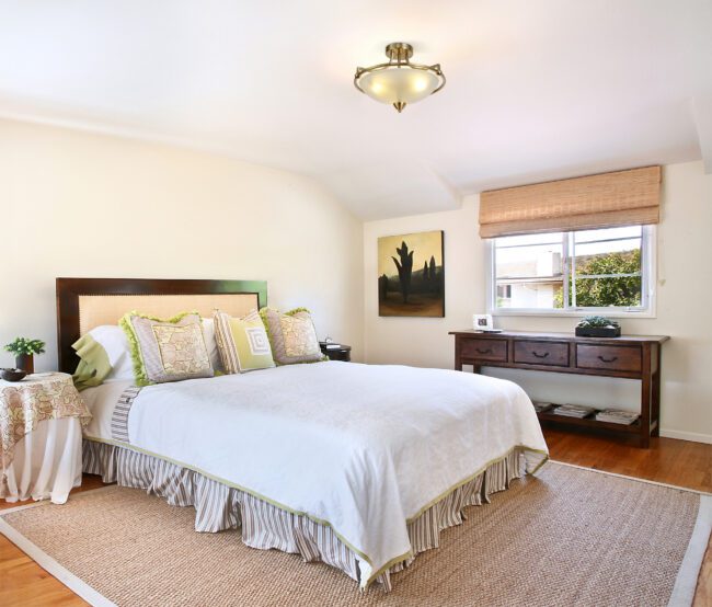 lavish_ Bright and neatly arranged bedroom with a Mia Semi Flush Ceiling, 3 Light E27, Satin Nickel/Frosted Glass, Southport-inspired wooden furniture, and decorative artwork.