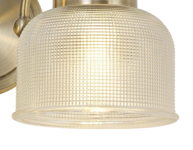 lavish_ Close-up of a textured glass lampshade on a Helena Switched Wall Lamp 2 Light E27 Antique Brass / Prismatic Glass fixture perfect for Southport home decor.