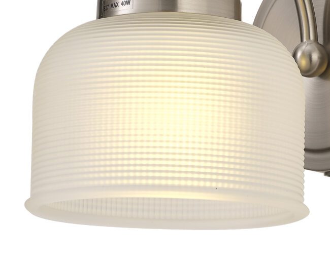 lavish_ Close-up of a lit Helena Switched Wall Lamp 1 Light E27 Satin Nickel / Frosted Glass lampshade with ridges, perfect for Southport home decor.
