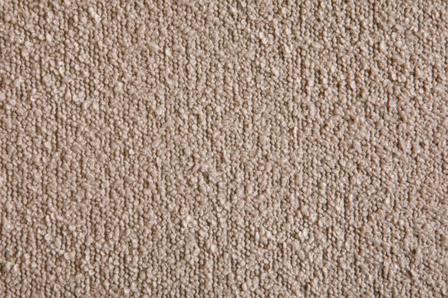 lavish_ Close-up texture of a Barefoot Dining Chair - Cream with a rough, granular appearance.