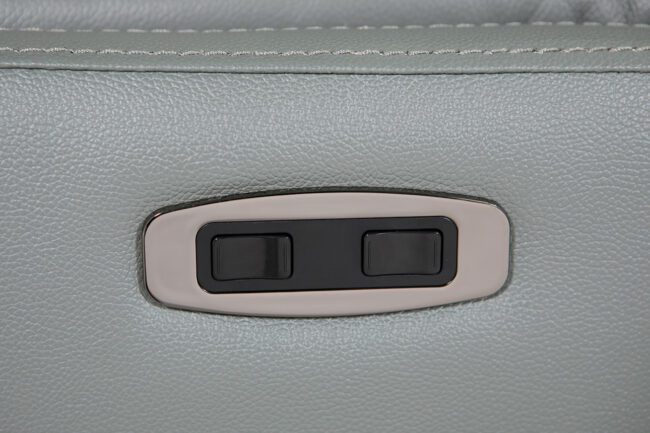 lavish_ Close-up of a car interior with a focus on the door control switches, reminiscent of Luca Electric Reclining Accent Chair - Steel's luxurious home decor.
