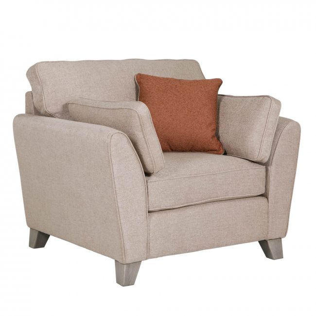 lavish_ Beige upholstered armchair with a brown accent pillow against a white background, perfect for Southport home decor and interior design.