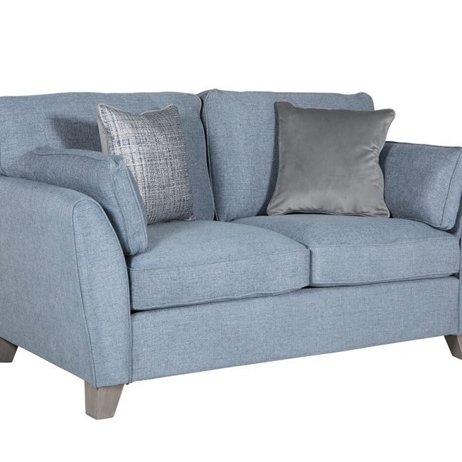 lavish_ A blue fabric loveseat with cushions on a white background, reflecting Southport-inspired home decor.