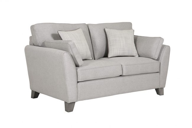 lavish_ A grey fabric loveseat with cushions, a perfect piece of Southport home decor furniture, against a white background.