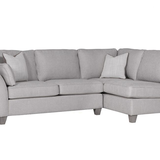 lavish_ A grey sectional sofa with cushions against a white background, perfect for enhancing your home decor.