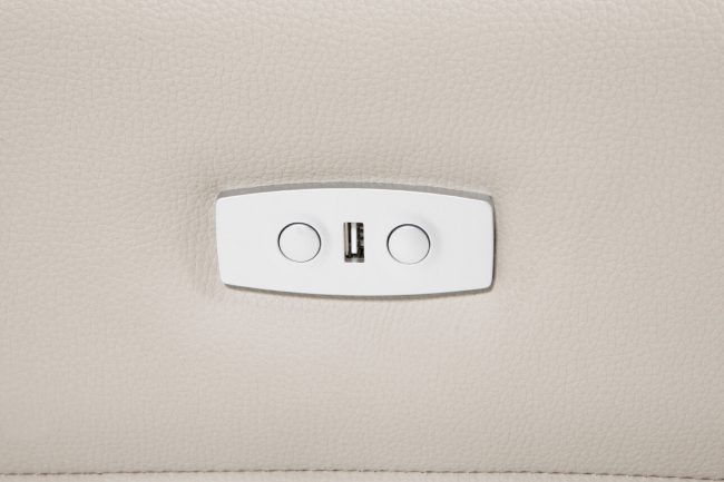 lavish_ Close-up view of a beige leather surface with a built-in round switch and USB port, ideal for Southport furniture and interior design.