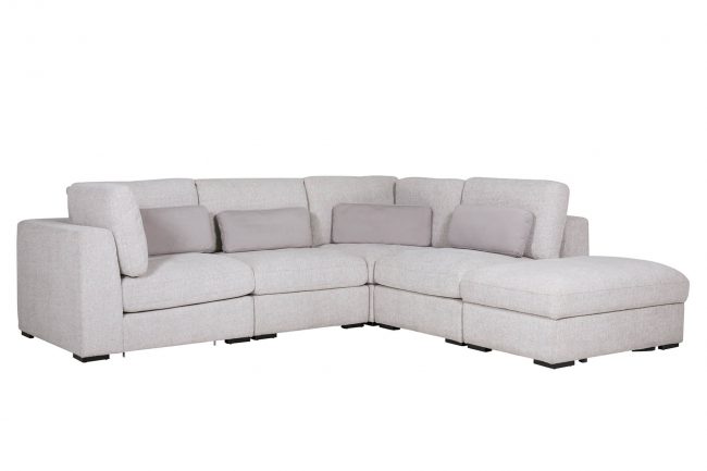 lavish_ L-shaped gray Humphrey Storage Ottoman Light Grey with chaise lounge and cushions.